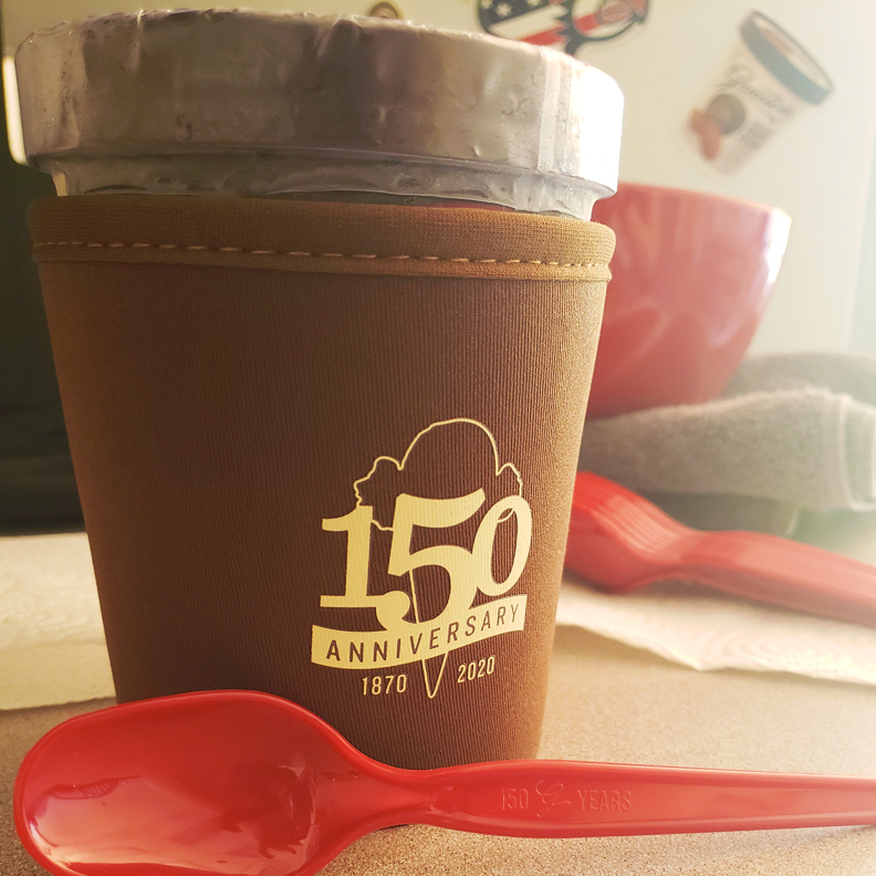 A coozie with the Graeter's logo on the front. It is the perfect size for a pint of ice cream. A plastic spoon also has the Graeter's logo stamped into the handle.