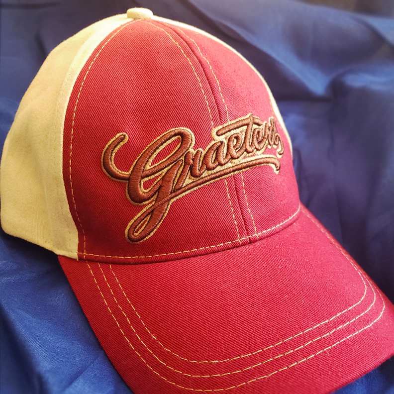 A red and white baseball cap with the Graeter's logo embroidered on the front.