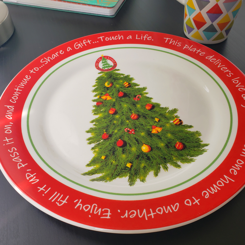 A dinner plate decorated with a christmas tree.